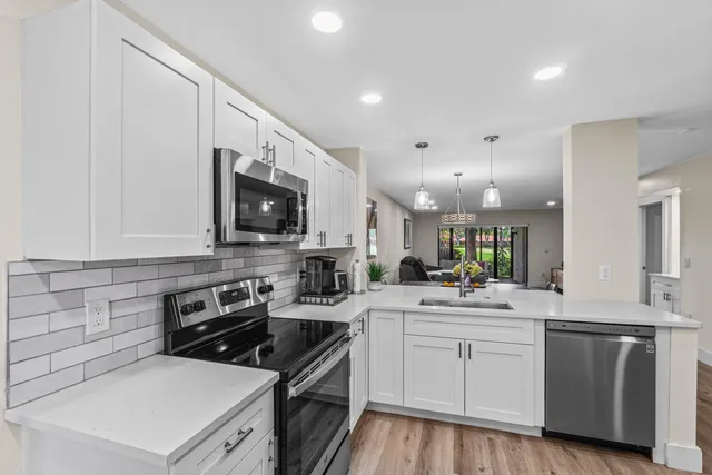 a kitchen with a refrigerator and a sink