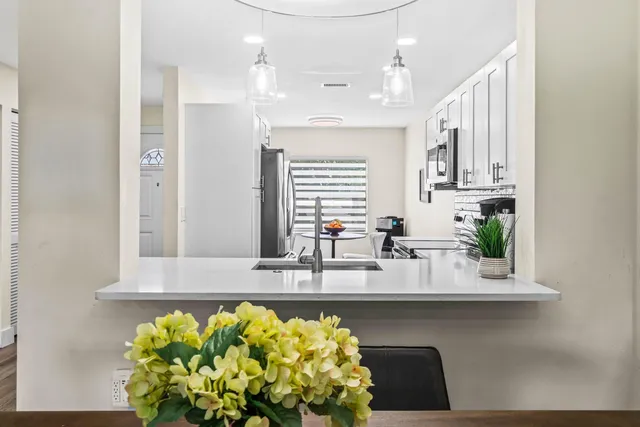a kitchen with a sink stove and microwave