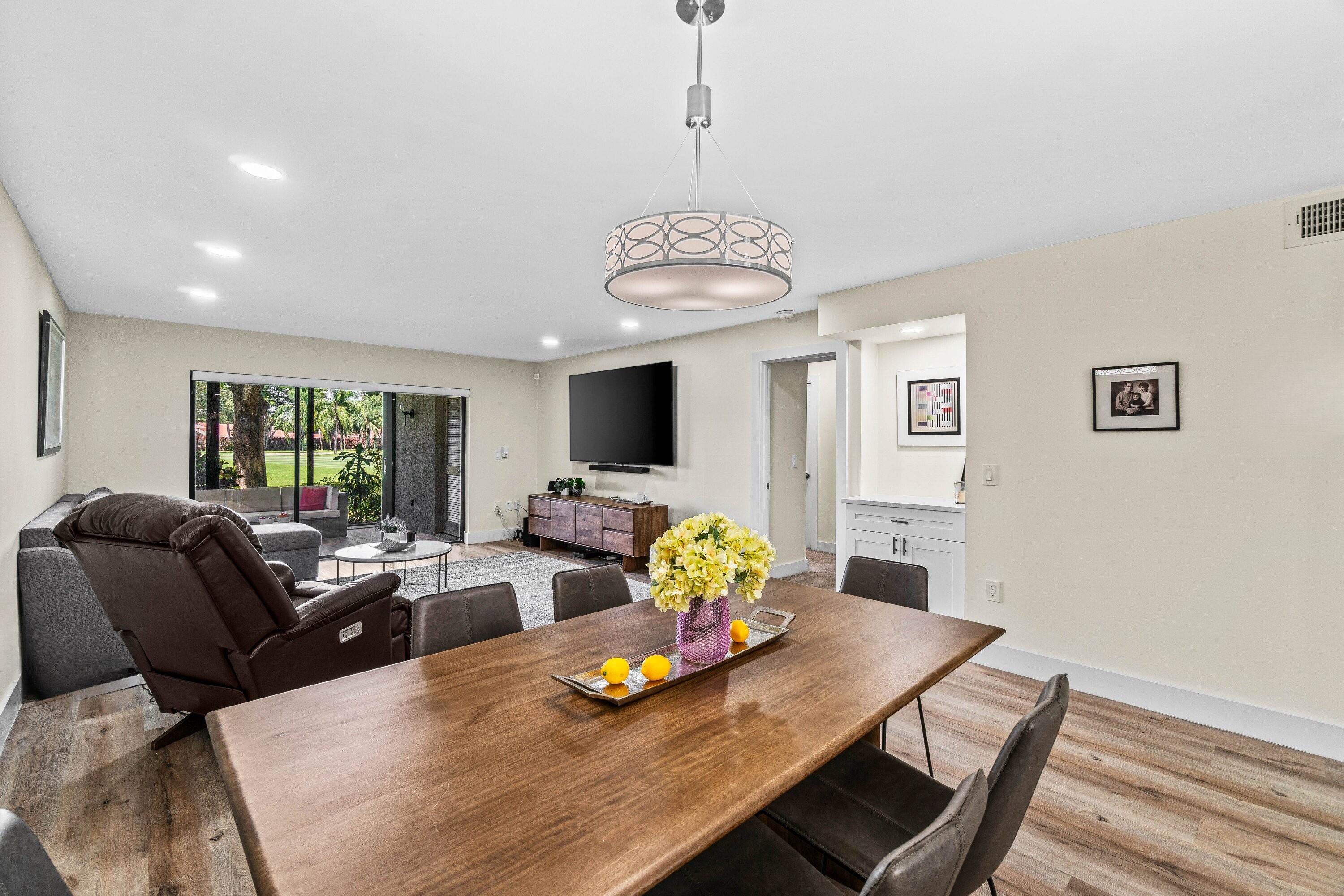 18 Stratford Drive, Unit E Boynton Beach, FL 33436 - Photo 6 of 49 a living room with furniture and a table