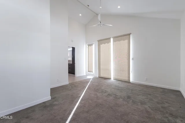 an empty room with closet and a hallway