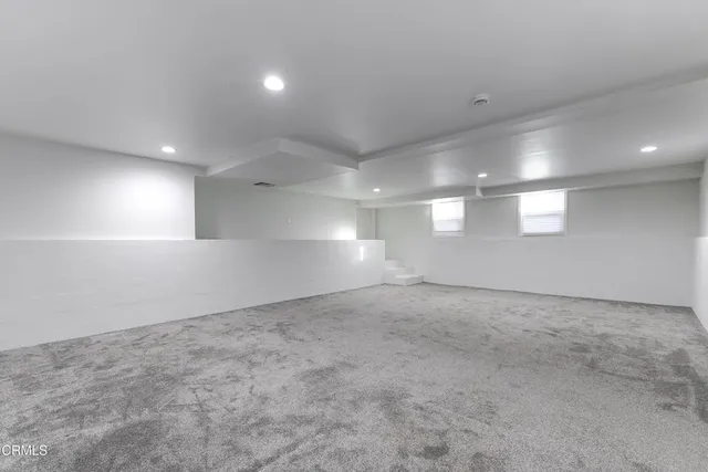 an empty room with a empty space and windows