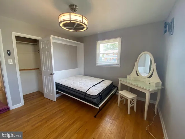 a bedroom with bed and a window