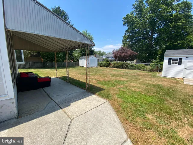 a view of backyard with trampoline