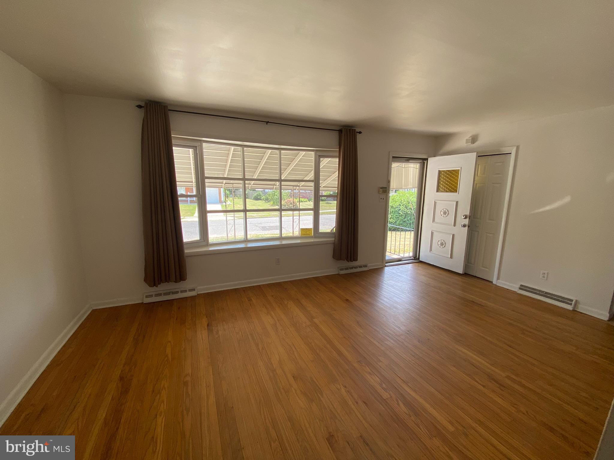 28 Fairmount Drive Glassboro, NJ 08028 - Photo 4 of 24 an empty room with wooden floor and windows