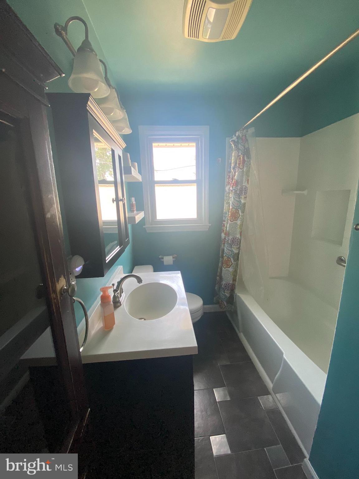 28 Fairmount Drive Glassboro, NJ 08028 - Photo 9 of 24 a bathroom with a sink a toilet and shower