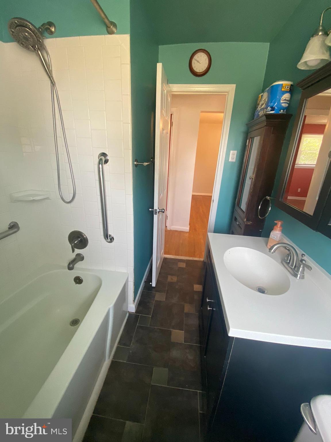 28 Fairmount Drive Glassboro, NJ 08028 - Photo 10 of 24 a bathroom with a tub sink and mirror