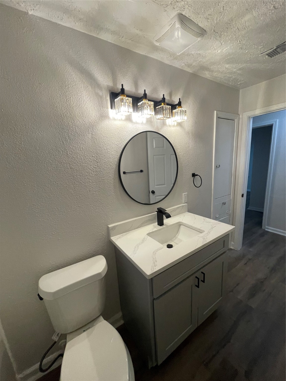 6003 Westover Street Houston, TX 77033 - Photo 13 of 19 a bathroom with a toilet sink and mirror
