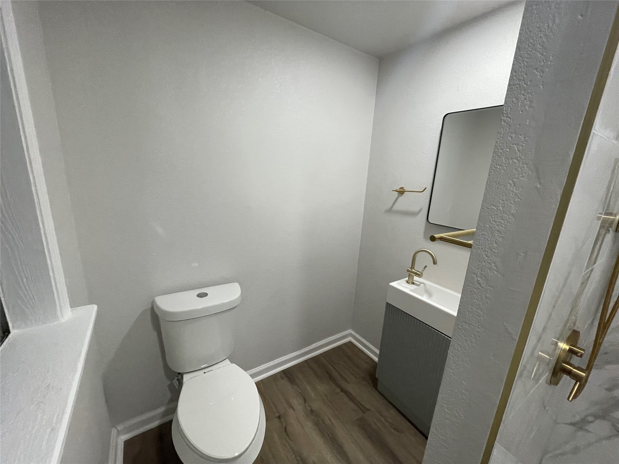 6003 Westover Street Houston, TX 77033 - Photo 18 of 19 a white toilet sitting next to a bathroom sink