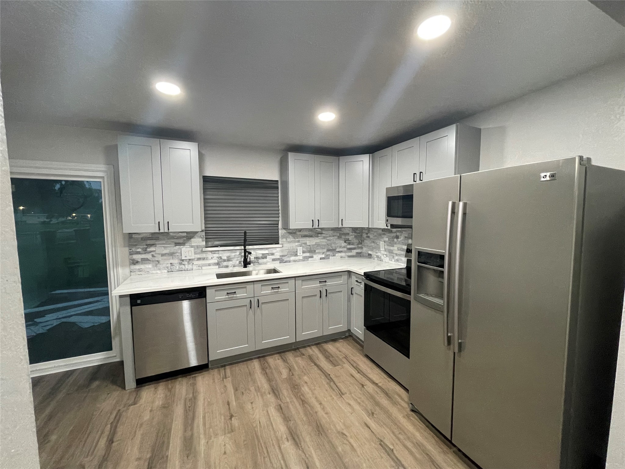 6003 Westover Street Houston, TX 77033 - Photo 2 of 19 a kitchen with stainless steel appliances granite countertop a refrigerator and a sink