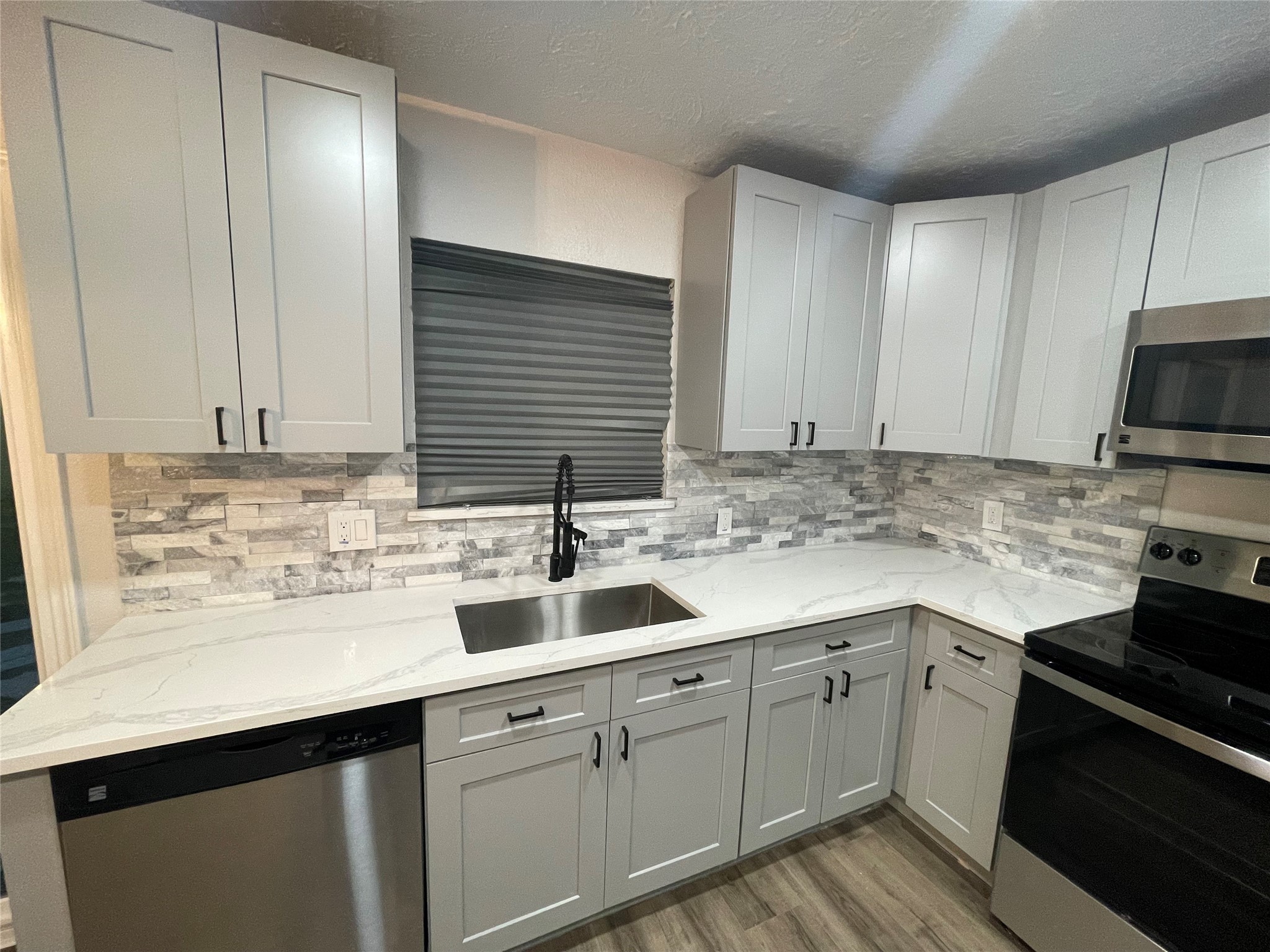 6003 Westover Street Houston, TX 77033 - Photo 3 of 19 a kitchen with a sink stove and cabinets