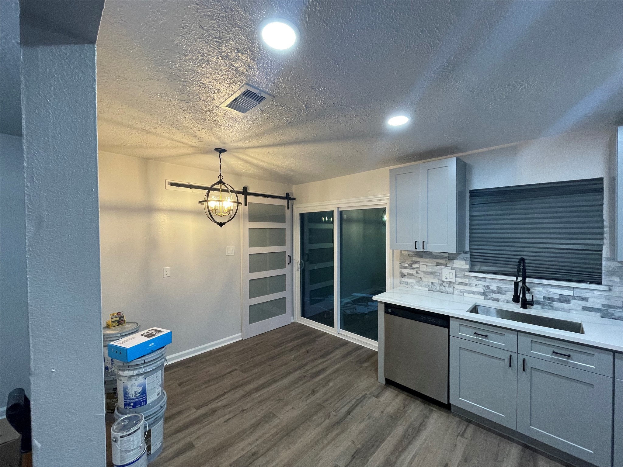 6003 Westover Street Houston, TX 77033 - Photo 6 of 19 a kitchen with sink cabinets and wooden floor