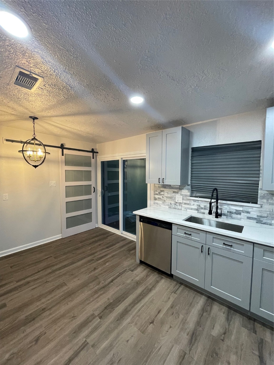 6003 Westover Street Houston, TX 77033 - Photo 7 of 19 a view of a kitchen with a sink and dishwasher with wooden floor