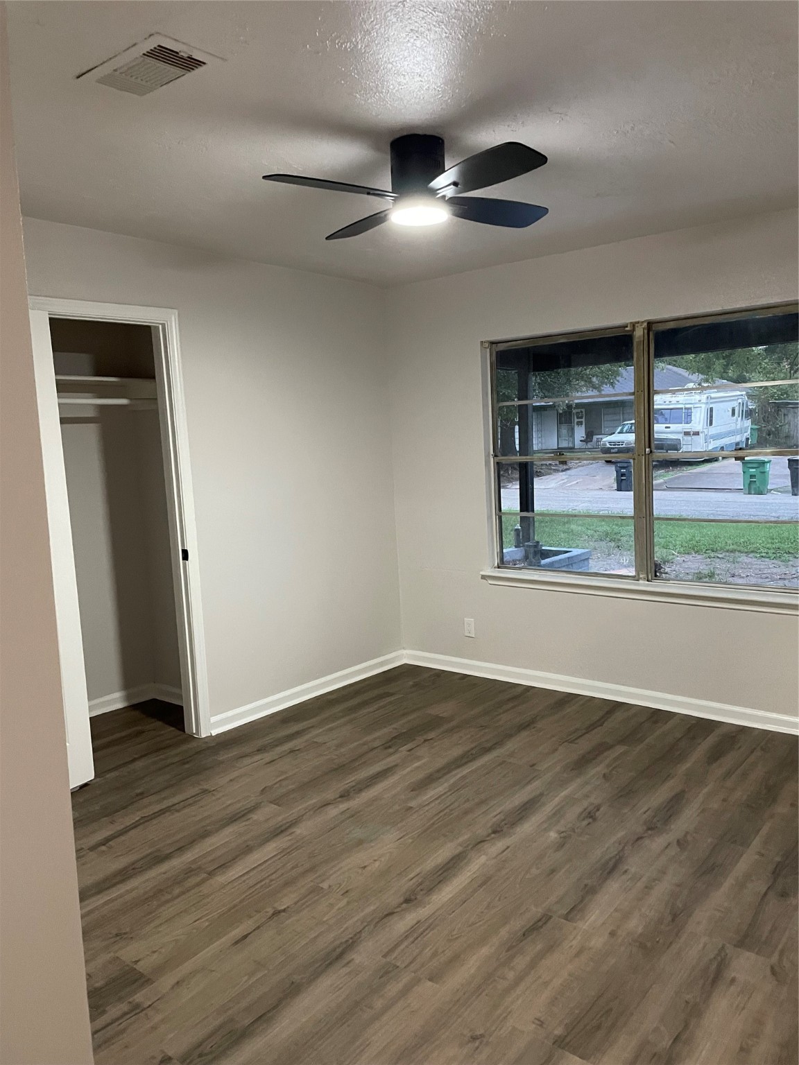6003 Westover Street Houston, TX 77033 - Photo 8 of 19 an empty room with wooden floor and windows