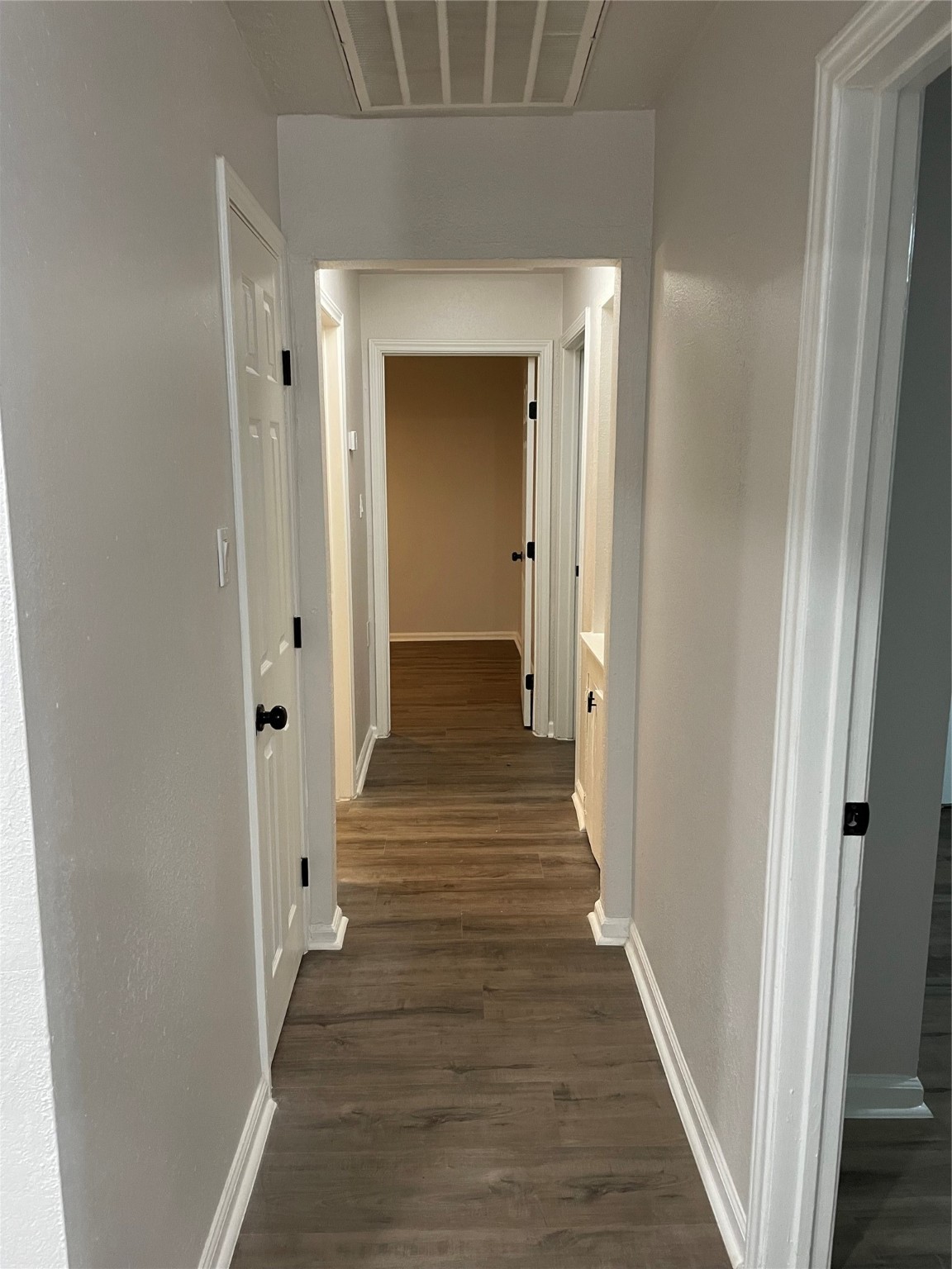 6003 Westover Street Houston, TX 77033 - Photo 9 of 19 a view of a hallway with wooden floor