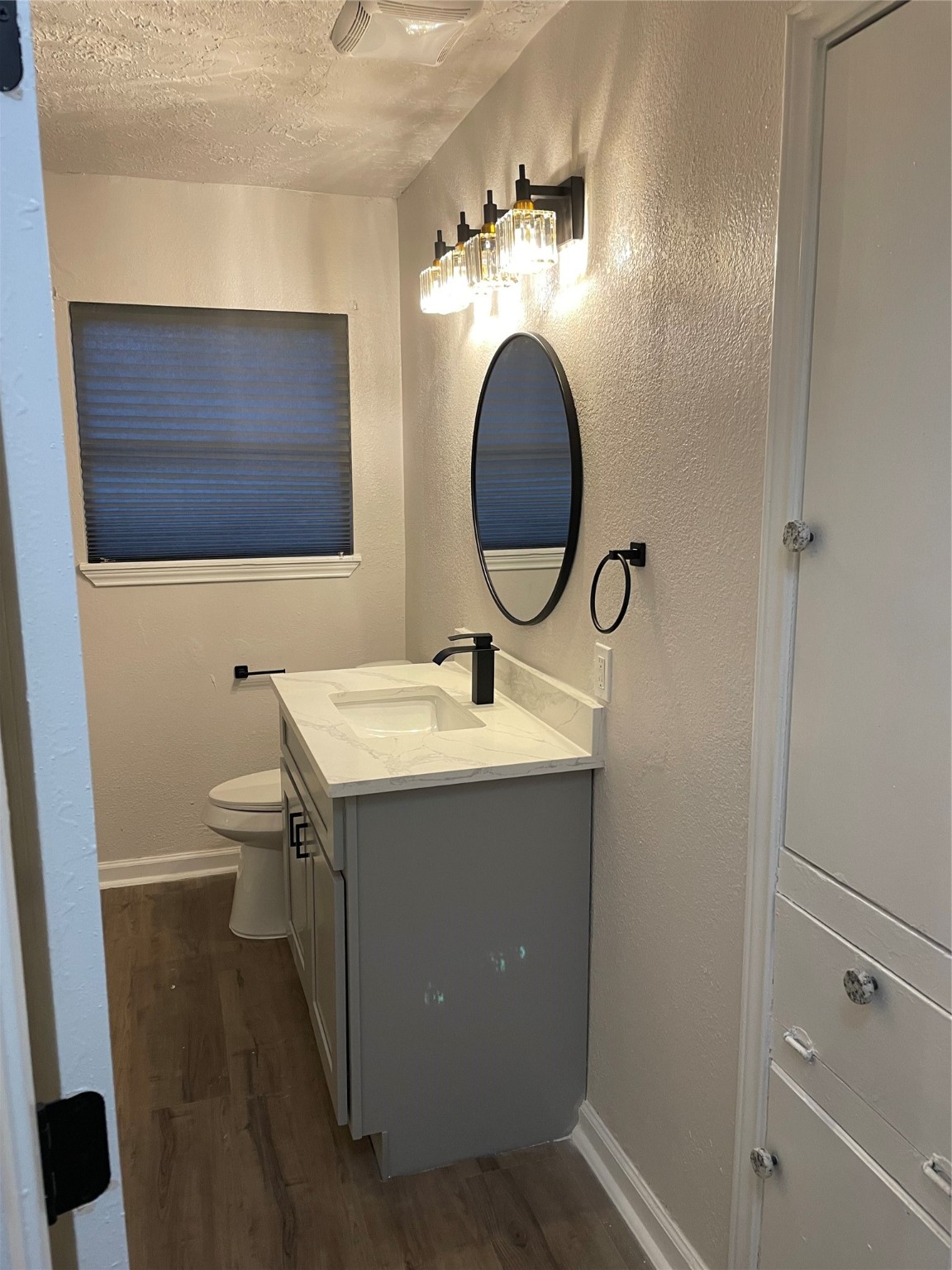 6003 Westover Street Houston, TX 77033 - Photo 10 of 19 a bathroom with a toilet sink and mirror