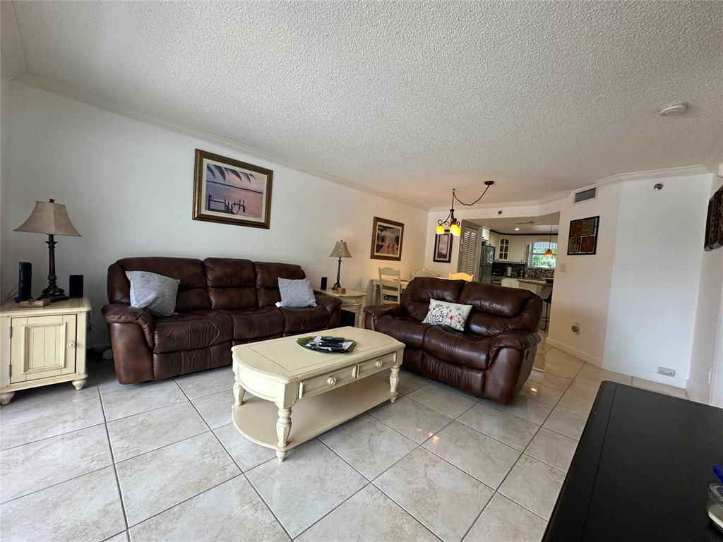 17801 North Bay Road, Unit 212 Sunny Isles Beach, FL 33160 - Photo 12 of 48 a living room with furniture and a couch