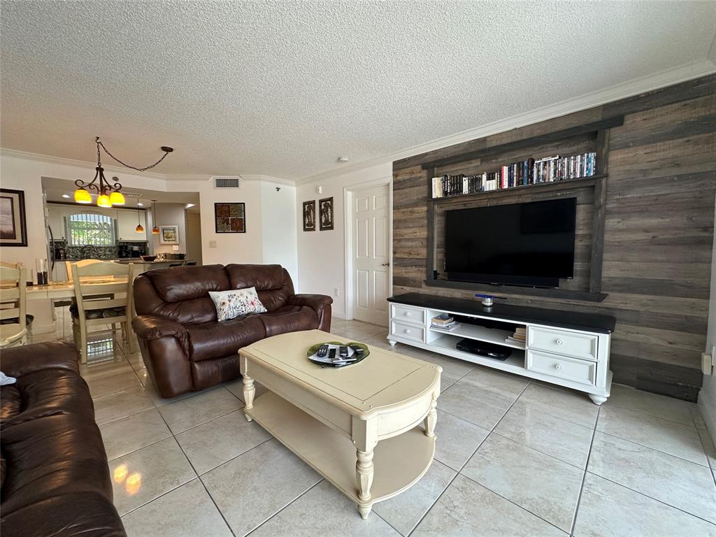 17801 North Bay Road, Unit 212 Sunny Isles Beach, FL 33160 - Photo 14 of 48 a living room with furniture and a flat screen tv