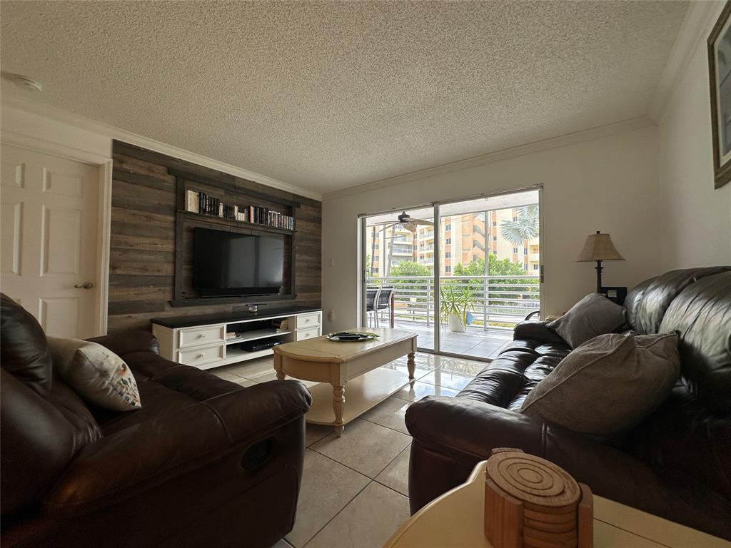 17801 North Bay Road, Unit 212 Sunny Isles Beach, FL 33160 - Photo 15 of 48 a living room with furniture and a flat screen tv