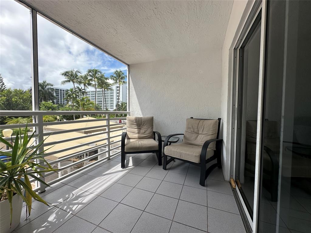 17801 North Bay Road, Unit 212 Sunny Isles Beach, FL 33160 - Photo 20 of 48 a balcony with chairs and with potted plants
