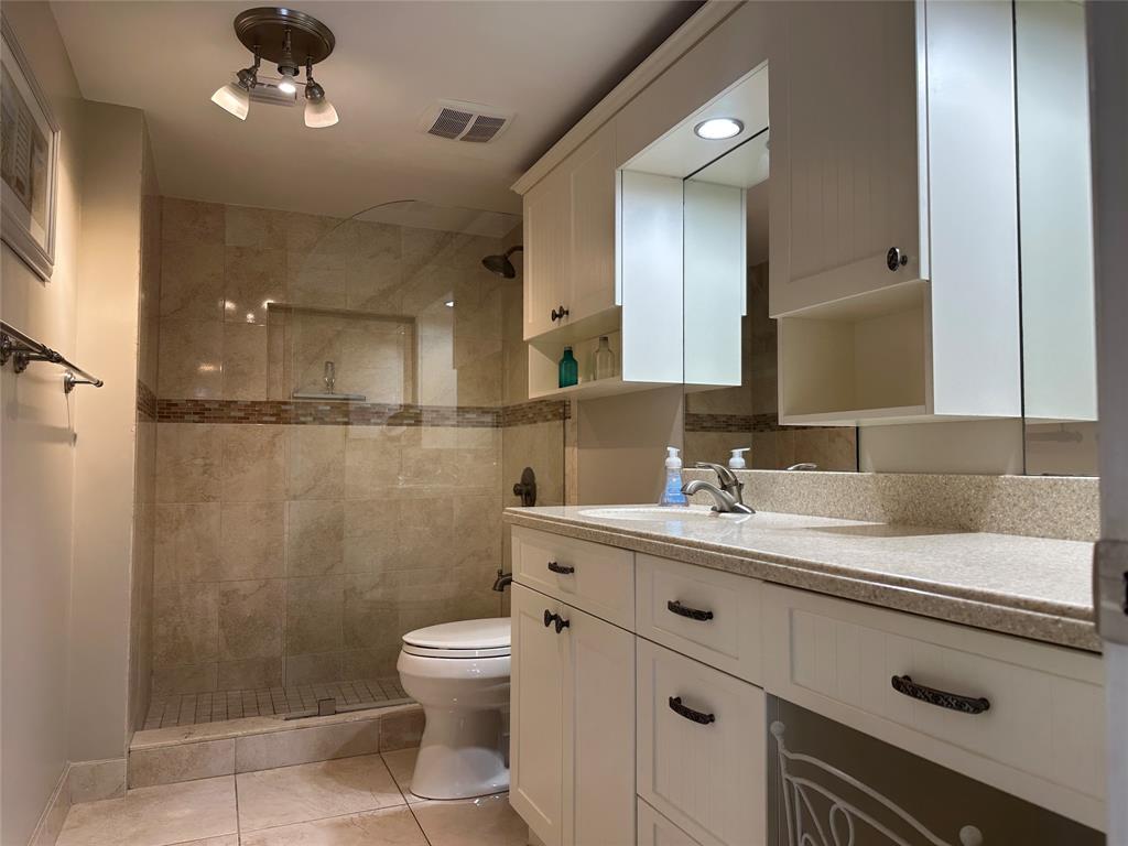 17801 North Bay Road, Unit 212 Sunny Isles Beach, FL 33160 - Photo 21 of 48 a bathroom with a sink a toilet and shower