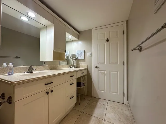 a spacious bathroom with a double vanity sink a mirror and a shower