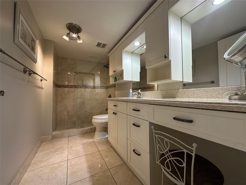 17801 North Bay Road, Unit 212 Sunny Isles Beach, FL 33160 - Photo 24 of 48 a spacious bathroom with a sink a toilet a mirror and shower