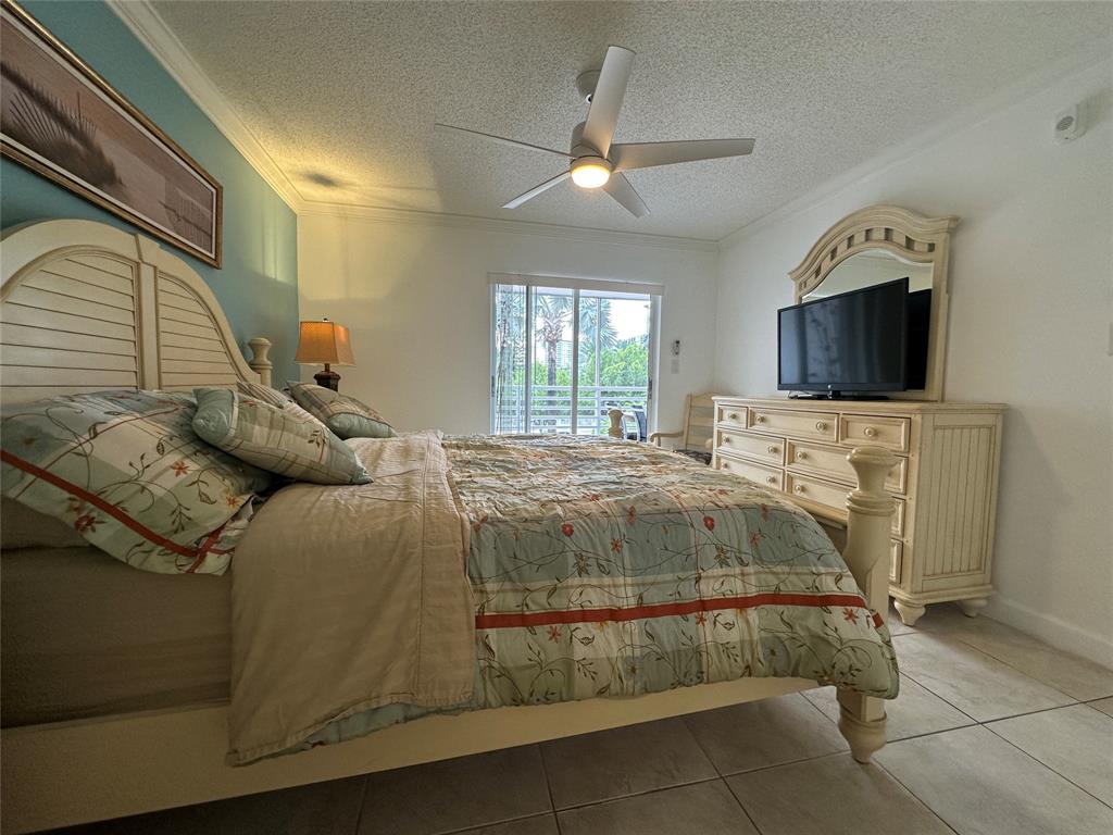 17801 North Bay Road, Unit 212 Sunny Isles Beach, FL 33160 - Photo 27 of 48 a bedroom with a bed and a flat screen tv