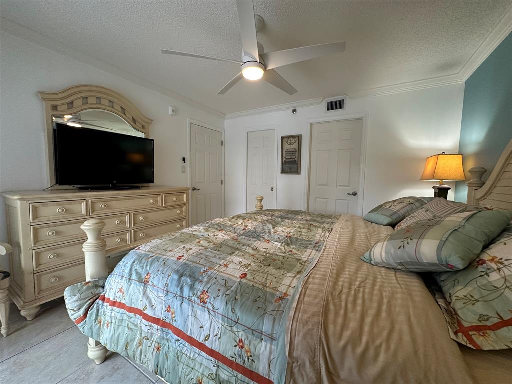 17801 North Bay Road, Unit 212 Sunny Isles Beach, FL 33160 - Photo 31 of 48 a bedroom with a bed and a flat screen tv