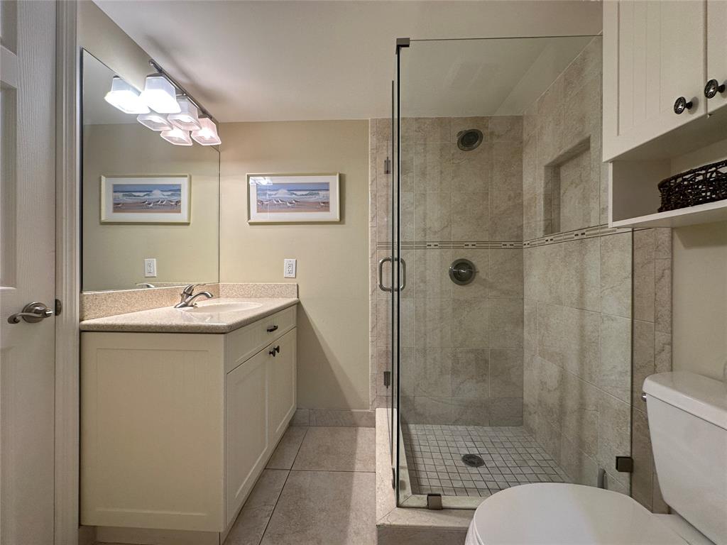 17801 North Bay Road, Unit 212 Sunny Isles Beach, FL 33160 - Photo 35 of 48 a bathroom with a granite countertop sink mirror shower and toilet