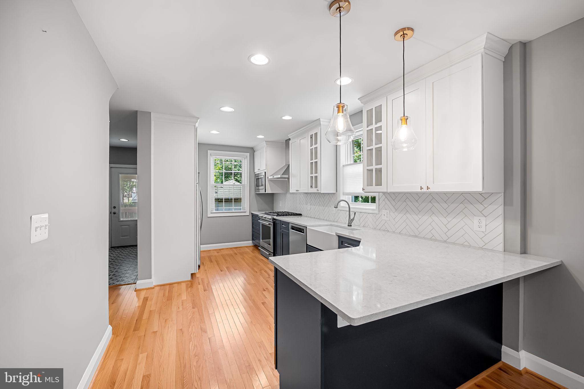 526 Dunkirk Road Baltimore, MD 21212 - Photo 12 of 44 a kitchen with a sink a counter space and stainless steel appliances