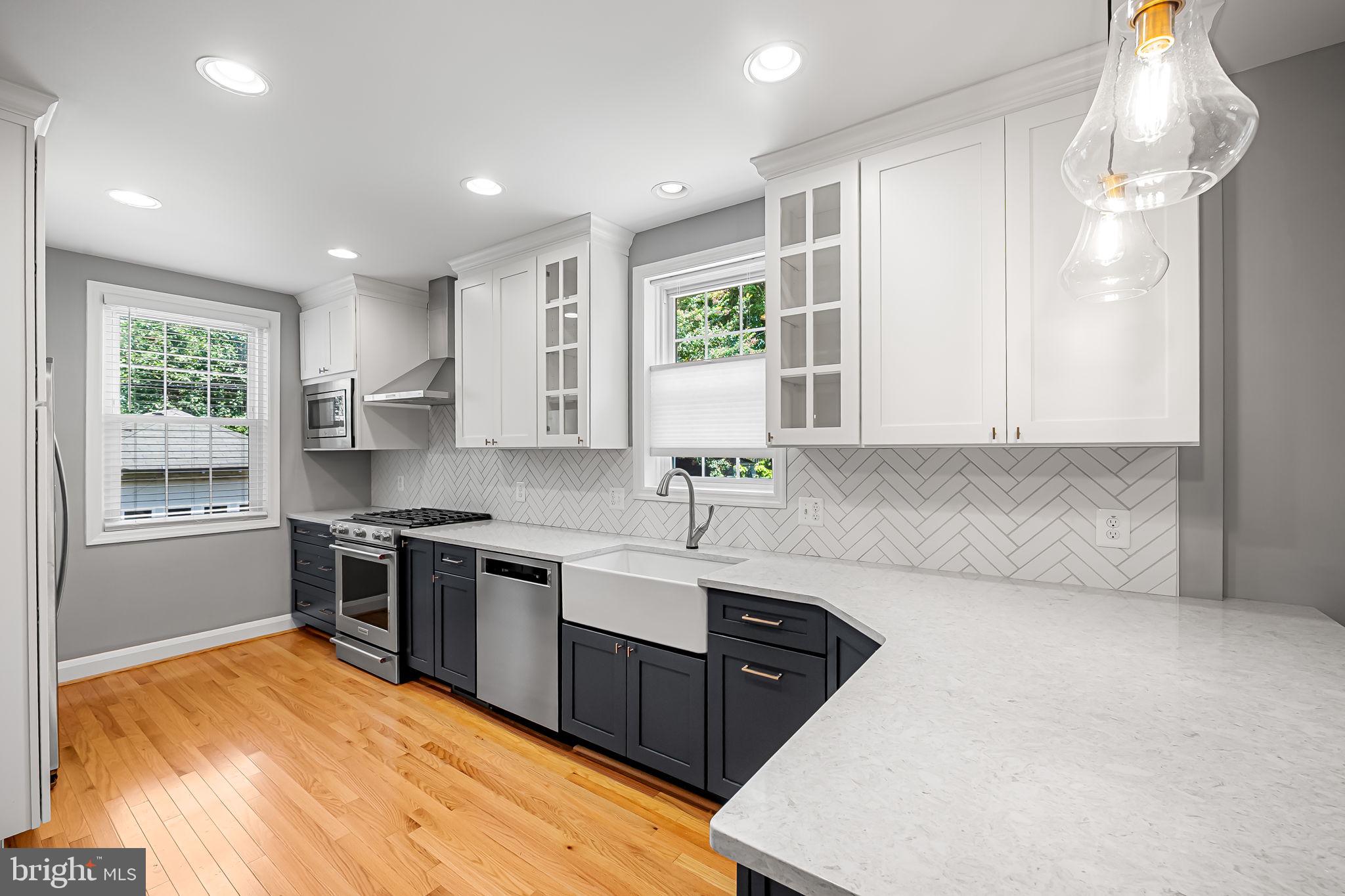 526 Dunkirk Road Baltimore, MD 21212 - Photo 13 of 44 a kitchen with stainless steel appliances granite countertop a sink stove and refrigerator