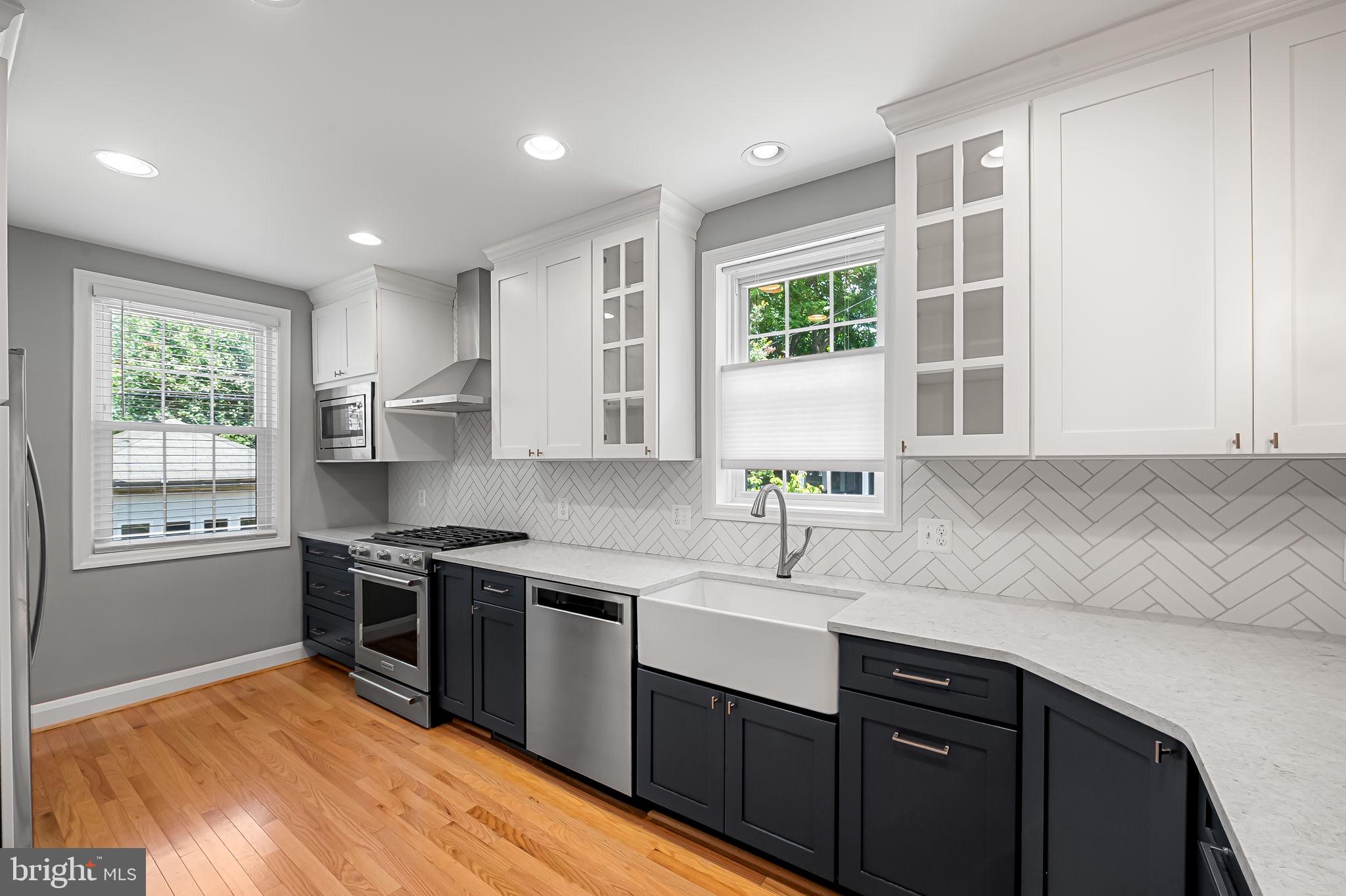 526 Dunkirk Road Baltimore, MD 21212 - Photo 14 of 44 a kitchen with stainless steel appliances granite countertop sink stove top oven and cabinets