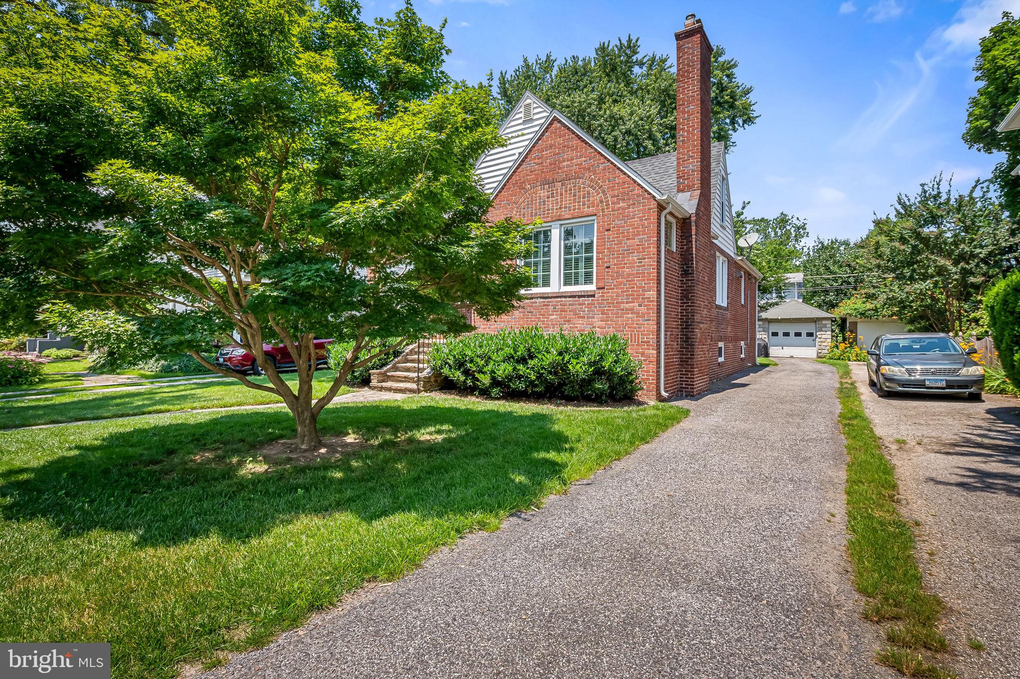 526 Dunkirk Road Baltimore, MD 21212 - Photo 4 of 44 a view of a yard in front of a house with plants and large tree