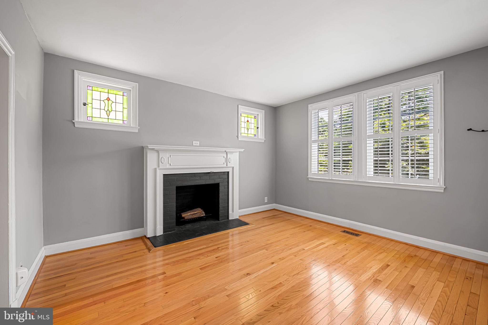 526 Dunkirk Road Baltimore, MD 21212 - Photo 7 of 44 a view of empty room with windows and fireplace