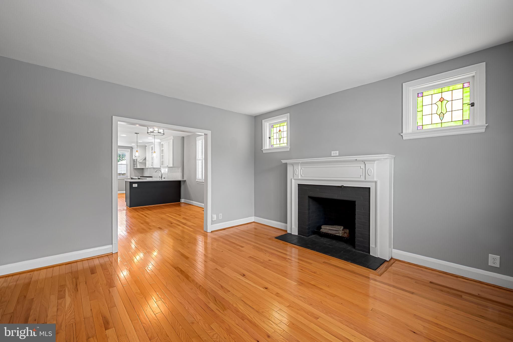 526 Dunkirk Road Baltimore, MD 21212 - Photo 8 of 44 a view of empty room with wooden floor and fireplace