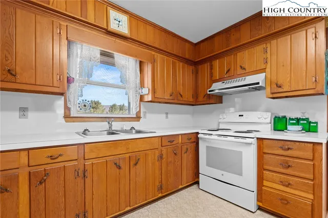 a kitchen with stainless steel appliances granite countertop a sink and cabinets