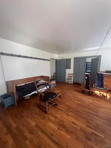 a living room with furniture a flat screen tv and gym equipment