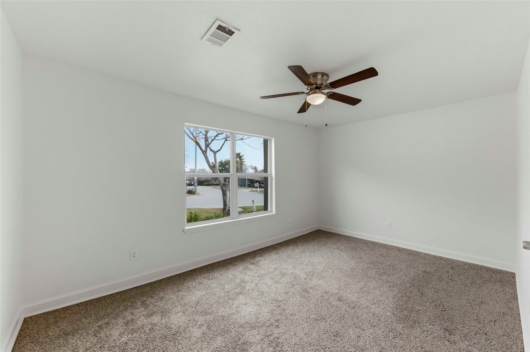 1909 Crooked Lane Austin, TX 78741 - Photo 18 of 25 Spare room with light carpet and ceiling fan