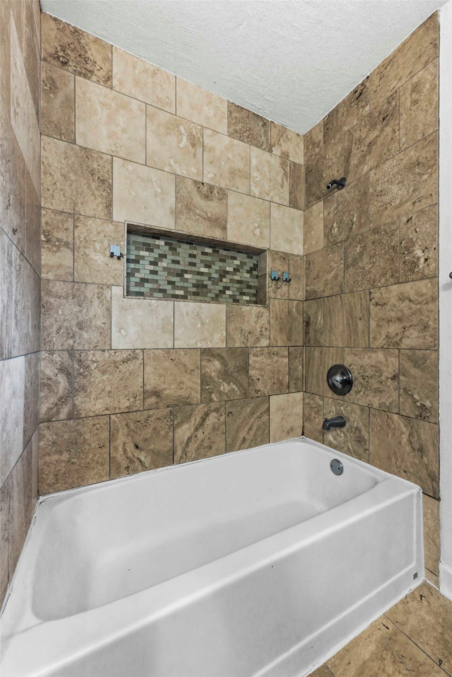 1909 Crooked Lane Austin, TX 78741 - Photo 20 of 25 Bathroom featuring shower / bathtub combination and a textured ceiling