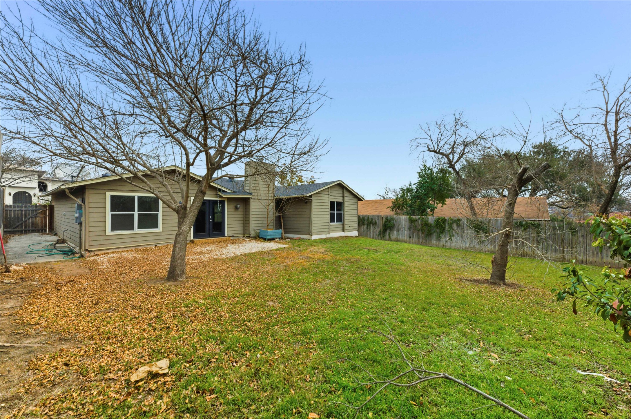 1909 Crooked Lane Austin, TX 78741 - Photo 23 of 25 Rear view of property with a fenced backyard and a patio