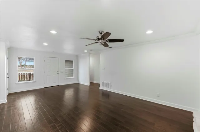 a kitchen with stainless steel appliances granite countertop a refrigerator a sink and white cabinets