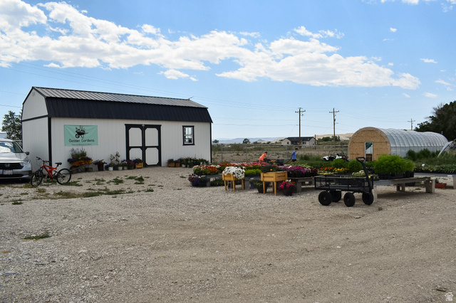 345 North Main Street Clawson, UT 84516 - Photo 14 of 17 White barn-style building with a black metal roof