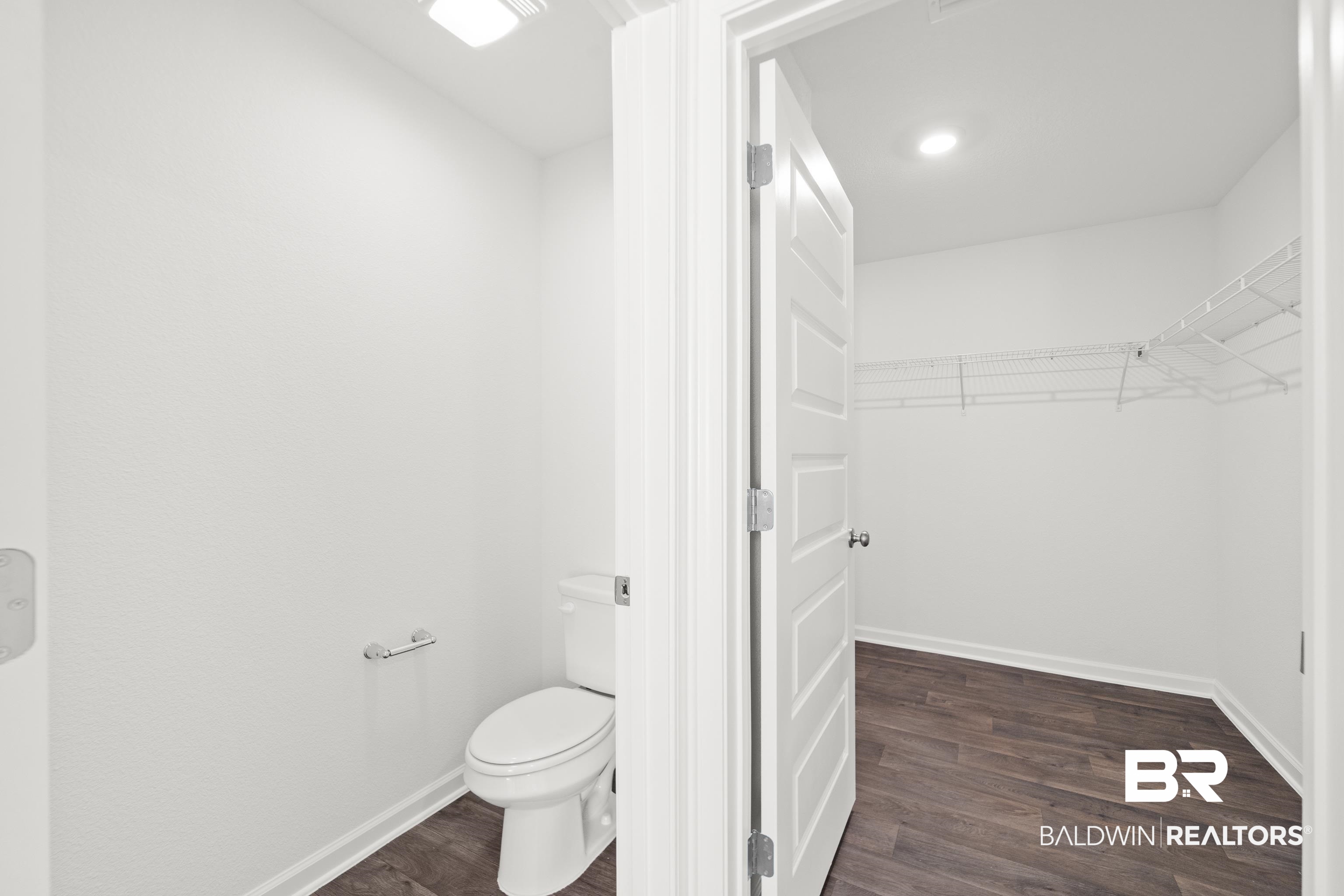 14615 Dayton Circle Foley, AL 36535 - Photo 23 of 27 entrance to separate toilet in primary bathroom and walk in closet.