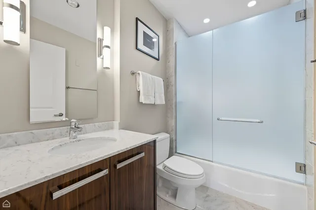 a living room with furniture and a potted plant on the wall