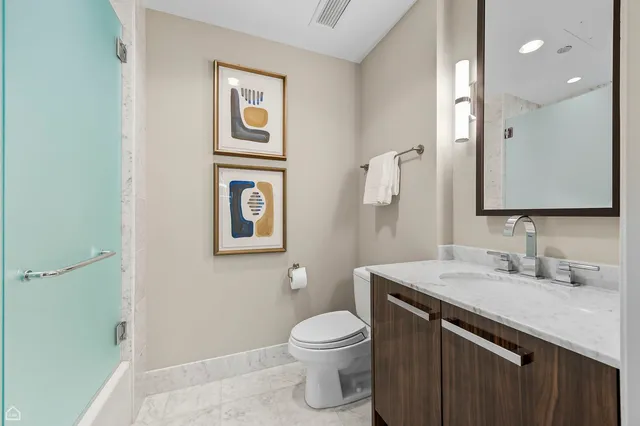 a bedroom with a bed and cabinets