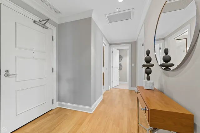 a view of a hallway with wooden floor and entryway