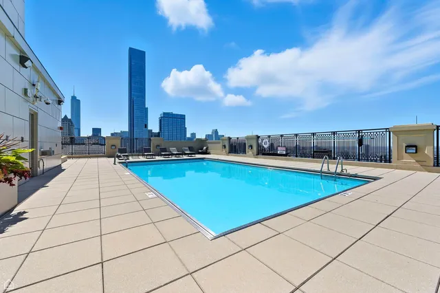 a living room with couches a flat tv screen and a dining table with wooden floor