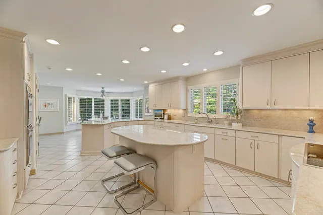 a kitchen with stainless steel appliances granite countertop a sink and a refrigerator