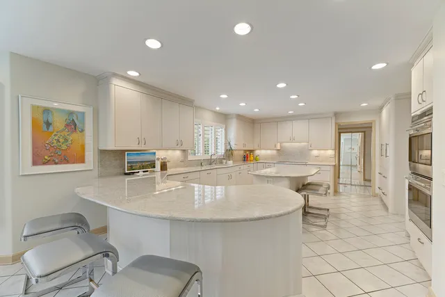 a living room with furniture and large windows