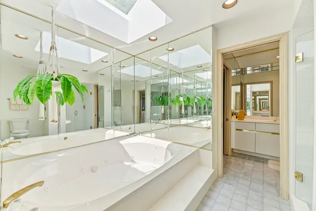 a bathroom with a double vanity sink and a mirror